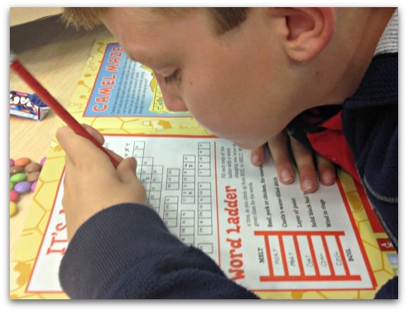 Concentrating hard on his Puzzle Club magazine