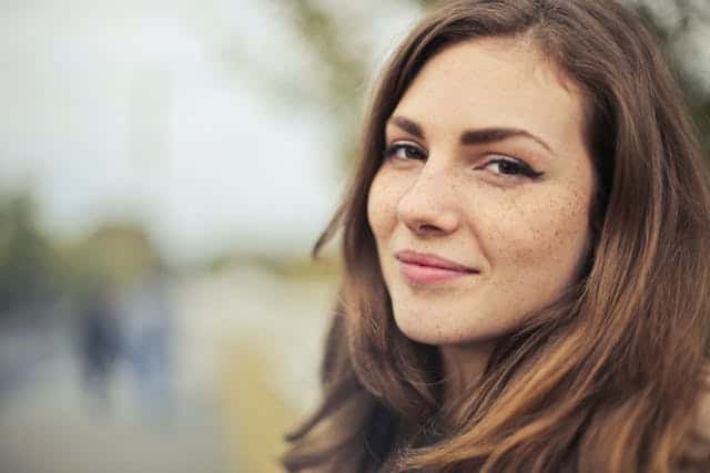 Woman with long brown hair smiling